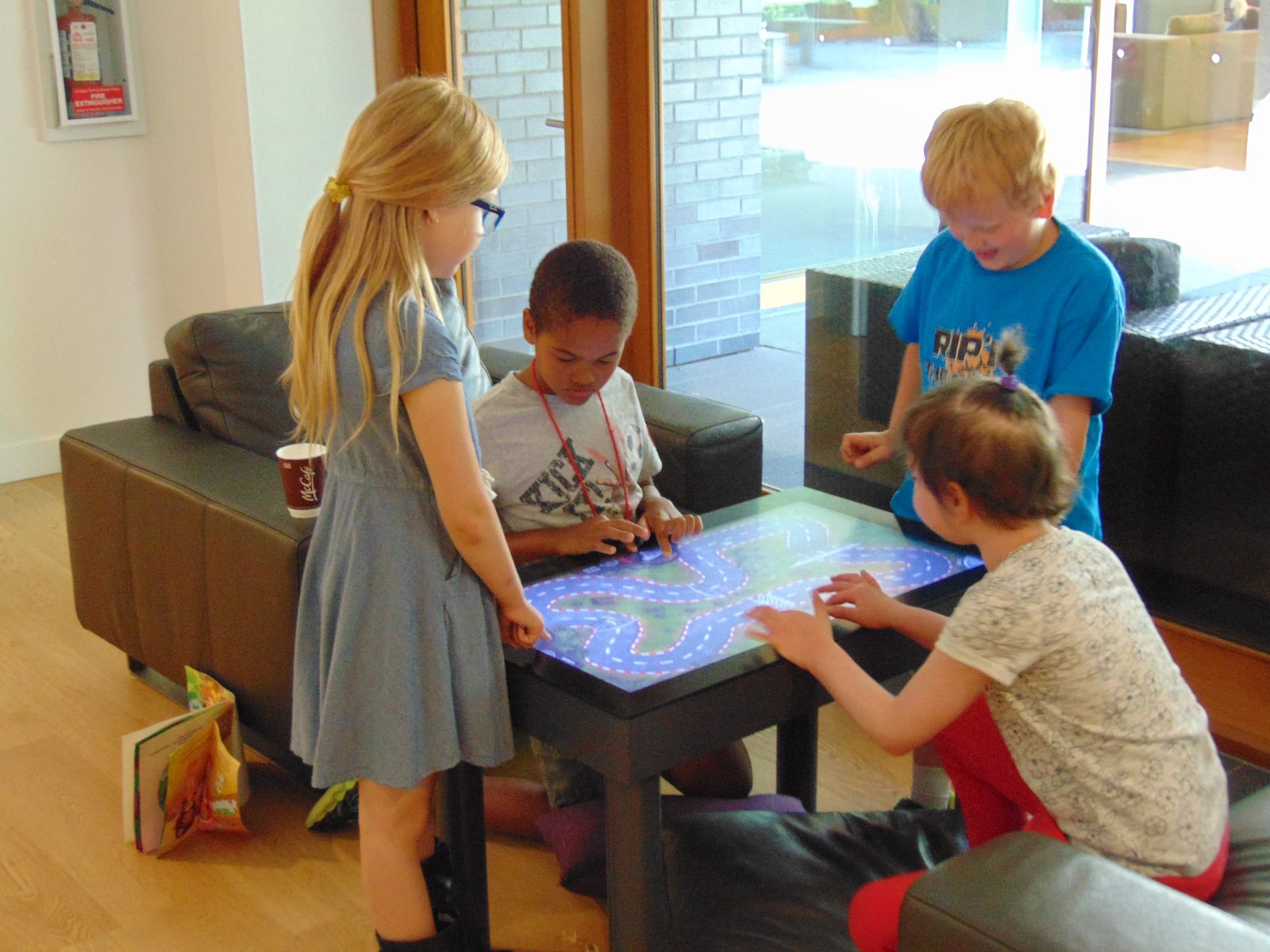 Children gathered around an interactive table at Ronald McDonald House British Columbia