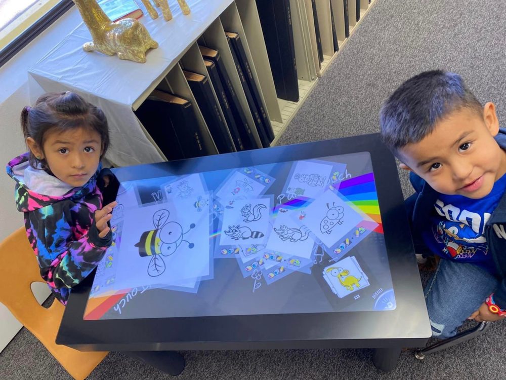 Children playing Paint’Touch at a library touch table