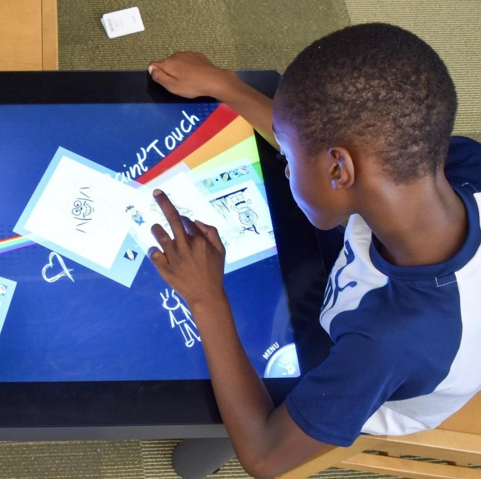 A child playing Paint’Touch on the touch table