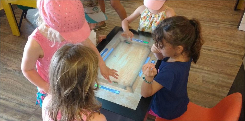 Children playing together on a PLAY touch table at Dreams Riviera Cancun